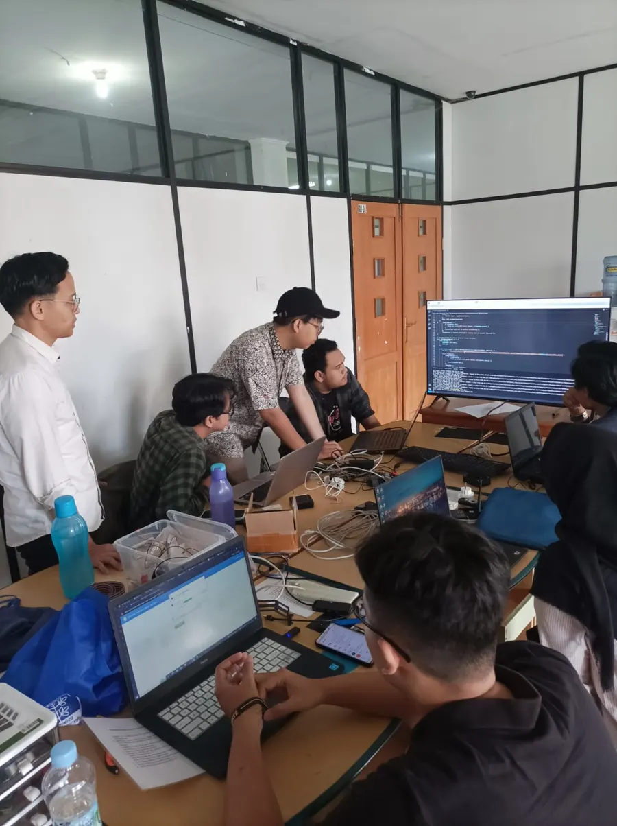 Project team reviewing a development workstation in a lab.